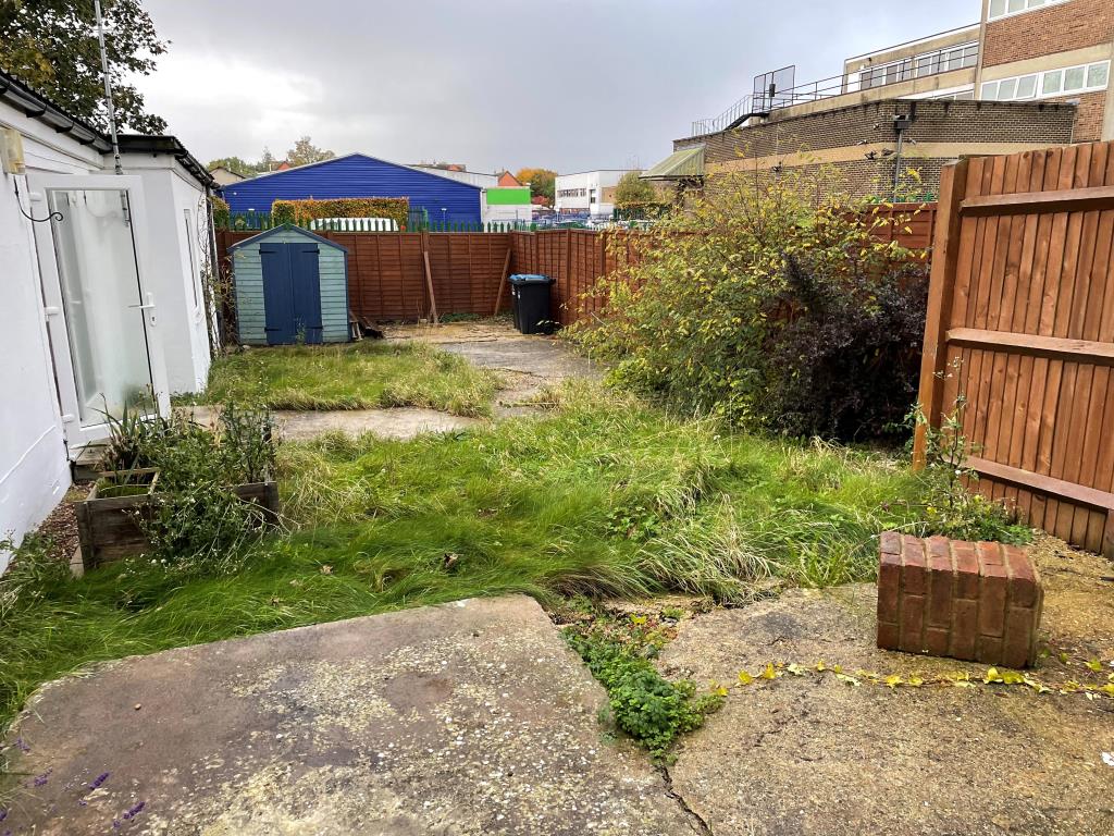 Lot: 136 - DETACHED BUNGALOW IN TOWN CENTRE - Garden view from north with lawn and shed